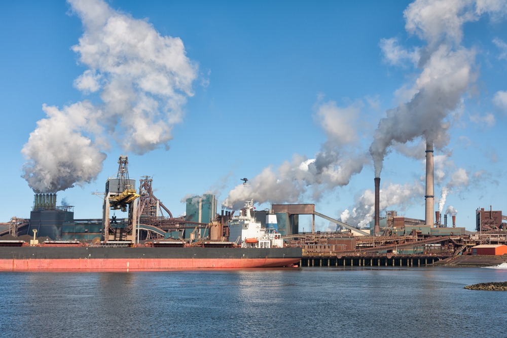 Big,ship,in,front,of,a,large,steel,factory,in
